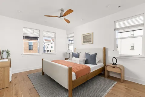 a bedroom with a bed a window and flowerpot