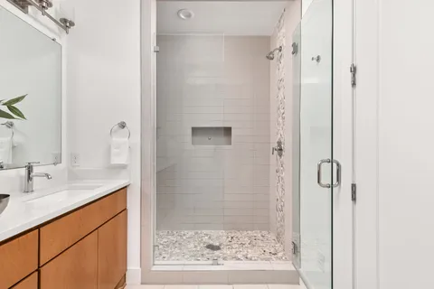 a bathroom with a granite countertop shower mirror and a sink