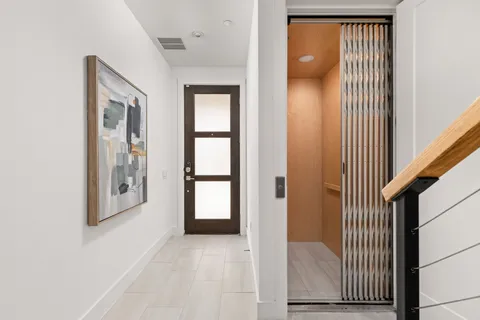 a view of a hallway with wooden floor and entryway