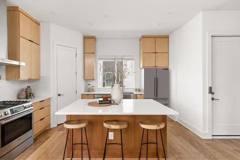 a kitchen with stainless steel appliances a sink stove and refrigerator