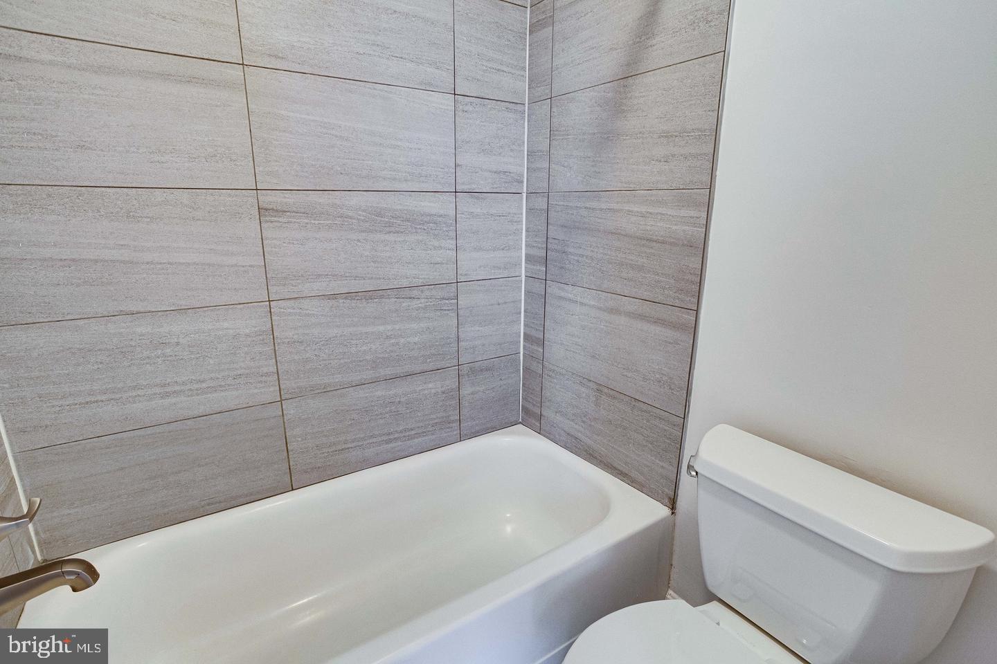 1836 Metzerott Road, Unit 2025 Adelphi, MD 20783 - Photo 14 of 21 a bathroom with a toilet and bathtub