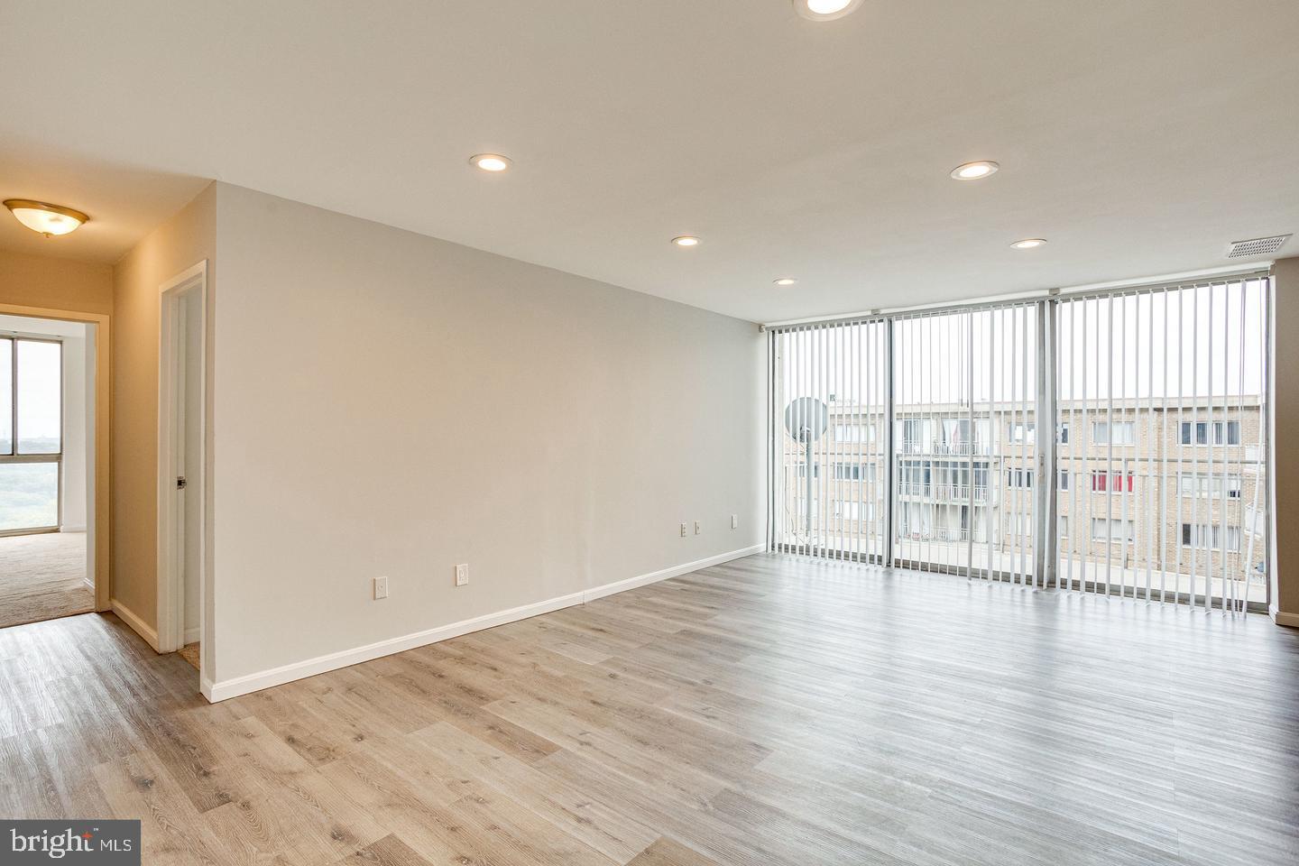 1836 Metzerott Road, Unit 2025 Adelphi, MD 20783 - Photo 4 of 21 a view of an empty room with wooden floor and a window