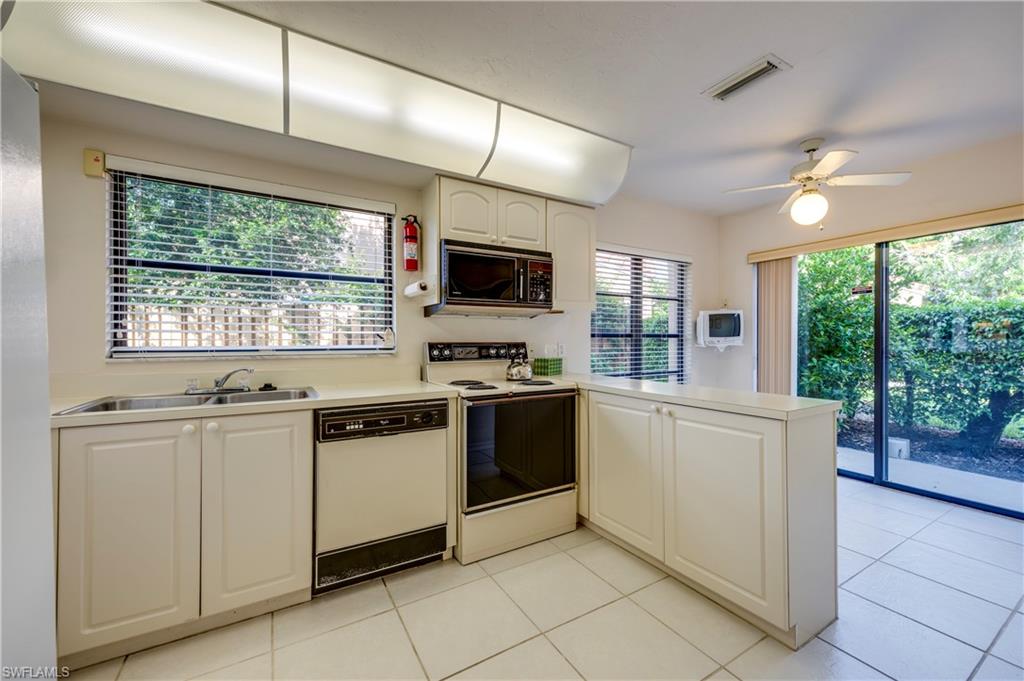 867 Reef Point Circle Naples, FL 34108 - Photo 12 of 32 Kitchen with breakfast nook & multiple windows for a bright work area