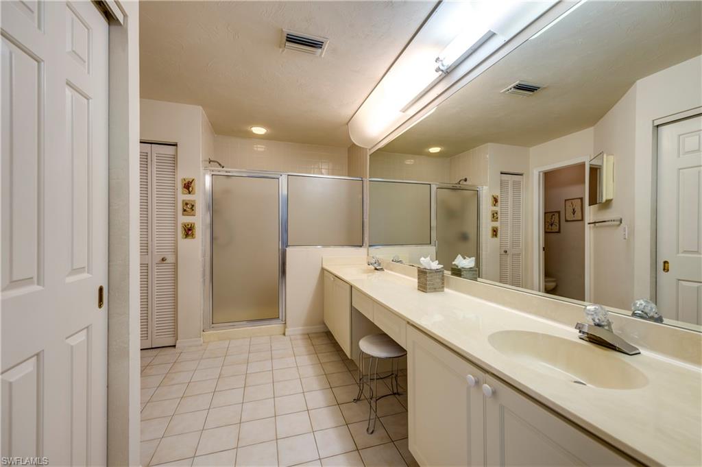 867 Reef Point Circle Naples, FL 34108 - Photo 18 of 32 Master Bathroom has private walk-in closet, double sinks, vanity & walk-in shower