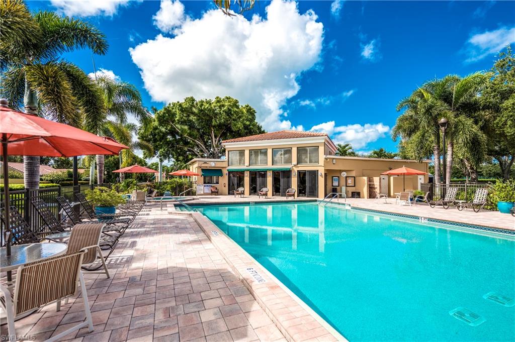 867 Reef Point Circle Naples, FL 34108 - Photo 29 of 32 Large pool area with loungers, spa, and water views
