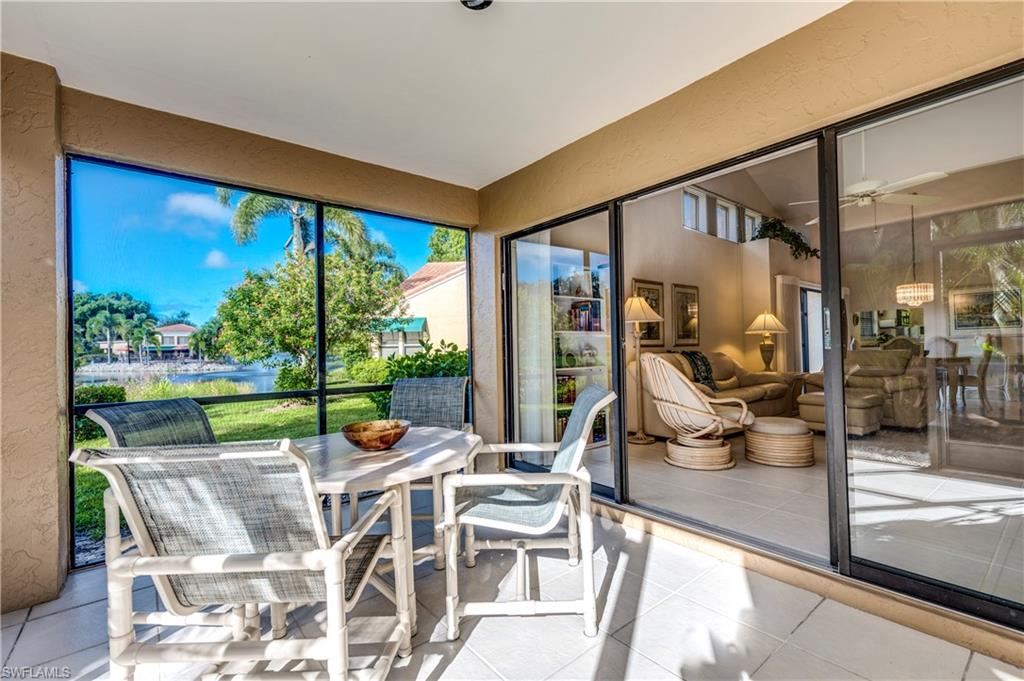 867 Reef Point Circle Naples, FL 34108 - Photo 8 of 32 Screened lanai offers relaxing lake views & access to side yard