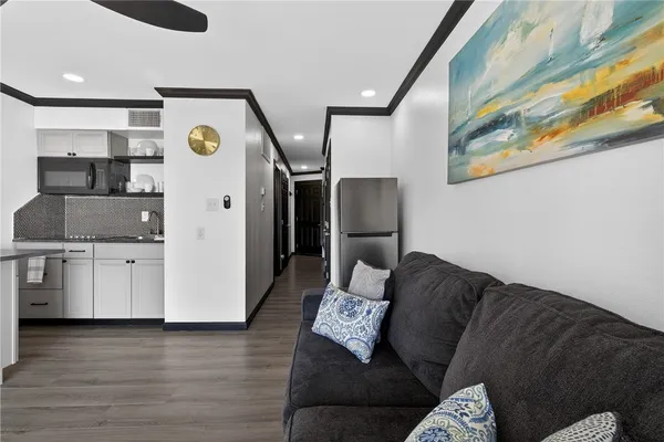 a living room with furniture and wooden floor
