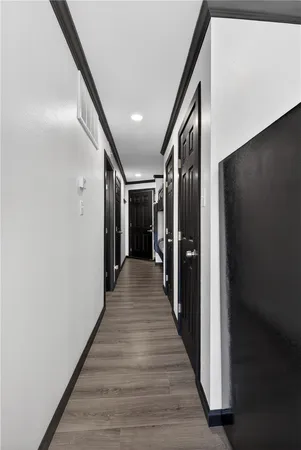 a hallway has a couch and a flat screen tv