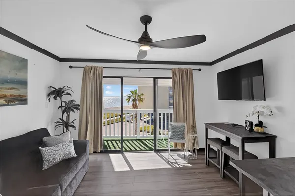a living room with furniture and kitchen view