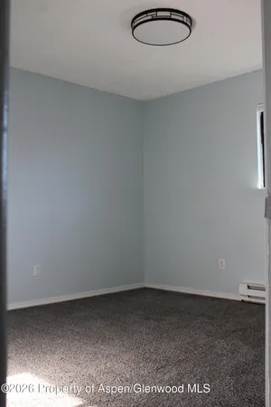 a spacious bedroom with a bed and a desk