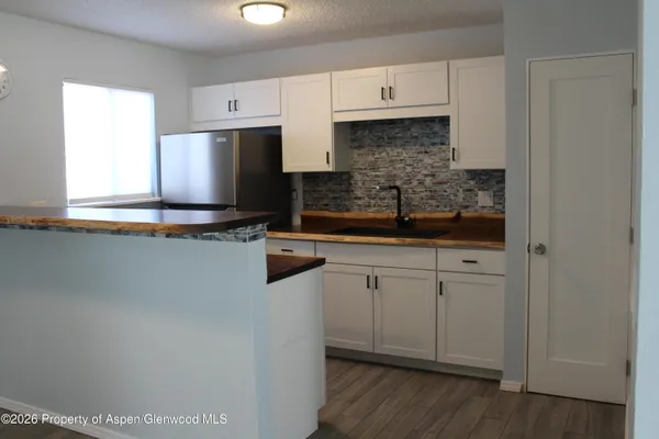 a kitchen with stainless steel appliances a sink and cabinets