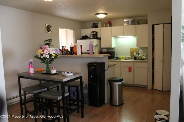 a kitchen with kitchen island a dining table and chairs