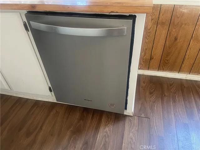 a view of walk in closet with wooden floor