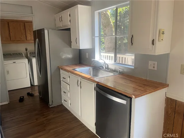 a kitchen with appliances cabinets and a sink