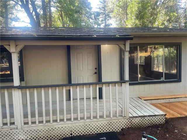 a view of a wooden house with a bench