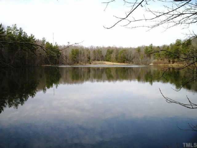 6710 Hebron Church Road Mebane, NC 27302 - Photo 1 of 12 Lake standing on dam face. Pasture in distance leads up to house.