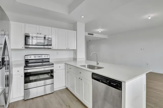 a kitchen with stainless steel appliances a stove sink and cabinets