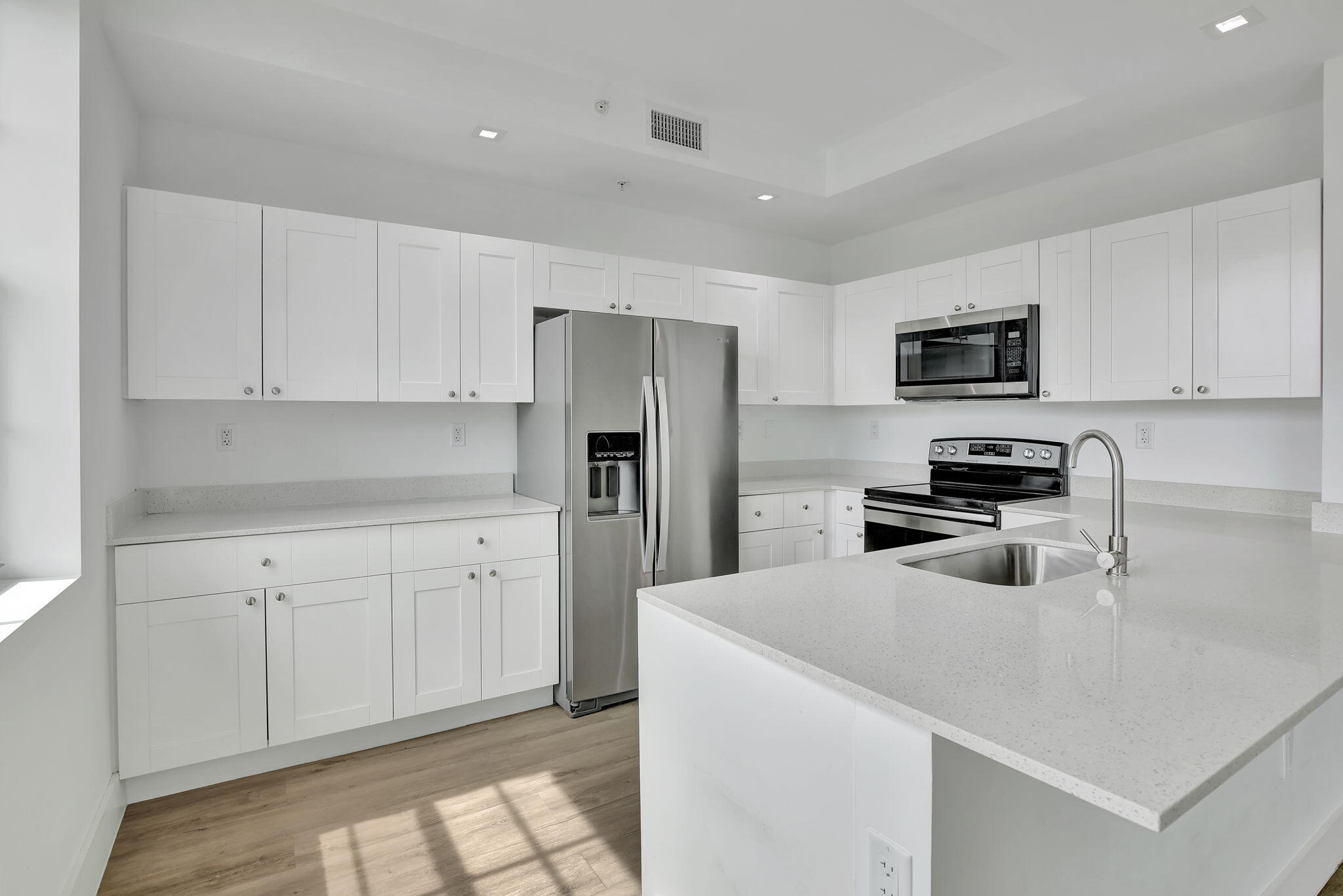 4100 Southwest 64th Avenue, Unit 315 Davie, FL 33314 - Photo 3 of 16 a kitchen with a refrigerator a microwave a sink and cabinets