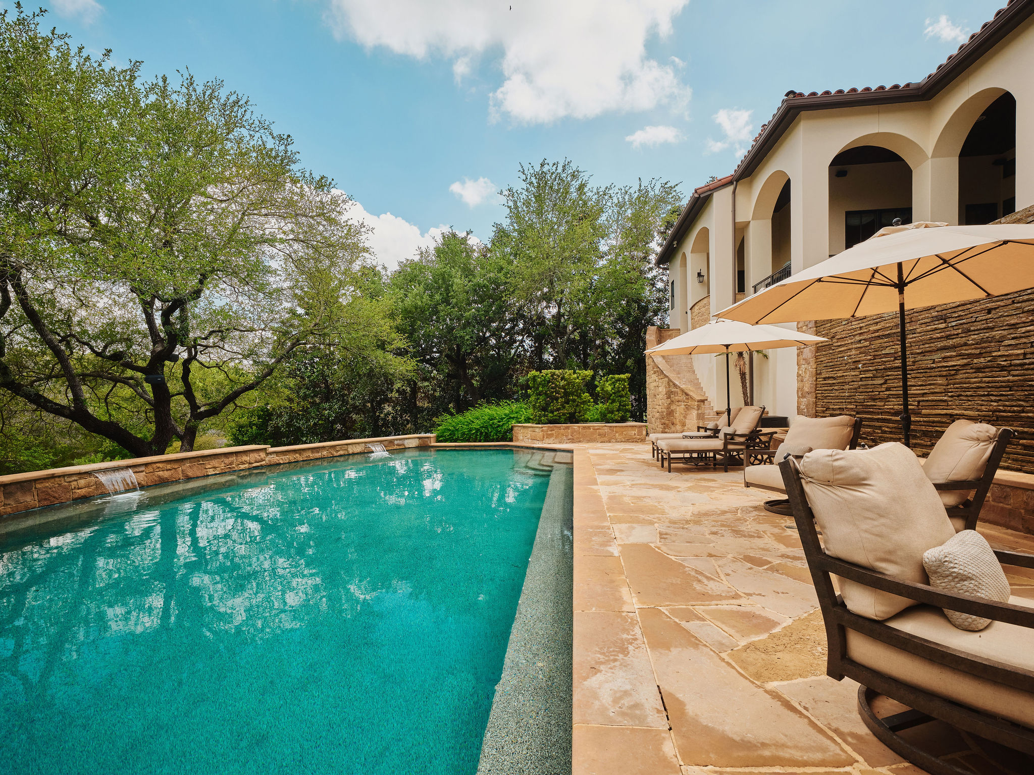433 Brandon Way Austin, TX 78733 - Photo 28 of 40 An inviting pool alongside a luxurious patio, perfect for leisurely outdoor living.