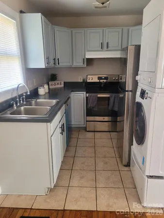 a kitchen with a sink a stove and cabinets