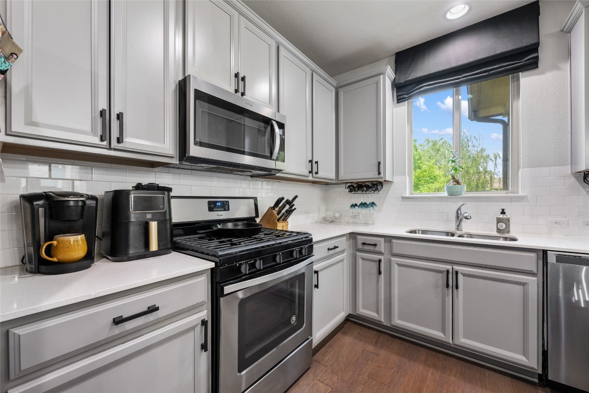 808 Bonnet Boulevard Georgetown, TX 78628 - Photo 18 of 40 a kitchen with stainless steel appliances granite countertop a sink a stove and cabinets