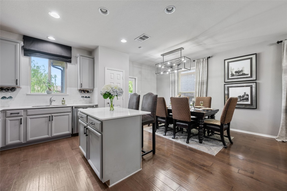808 Bonnet Boulevard Georgetown, TX 78628 - Photo 19 of 40 a kitchen with a table chairs stove and wooden floor