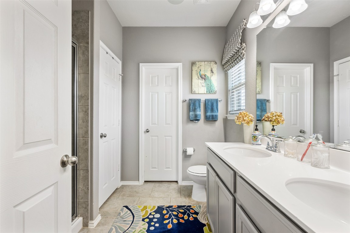 808 Bonnet Boulevard Georgetown, TX 78628 - Photo 22 of 40 a bathroom with a sink a mirror and a shower