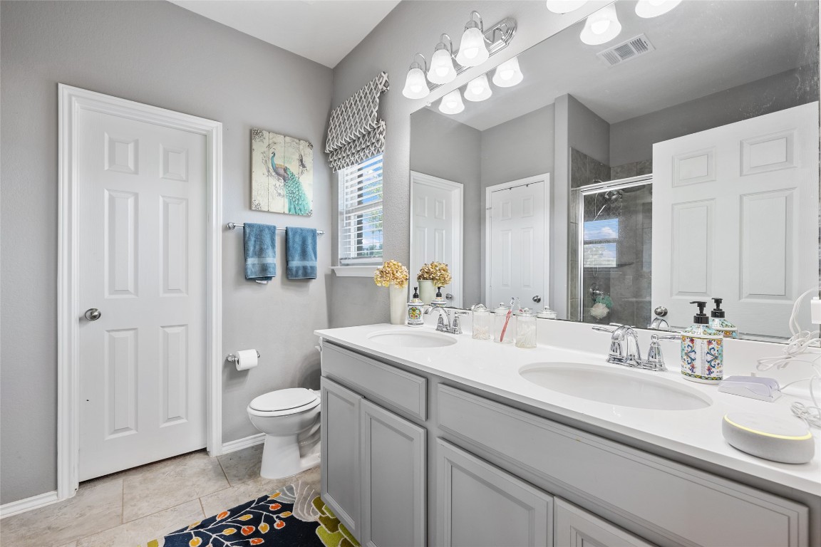 808 Bonnet Boulevard Georgetown, TX 78628 - Photo 23 of 40 a bathroom with a sink a toilet and a large mirror