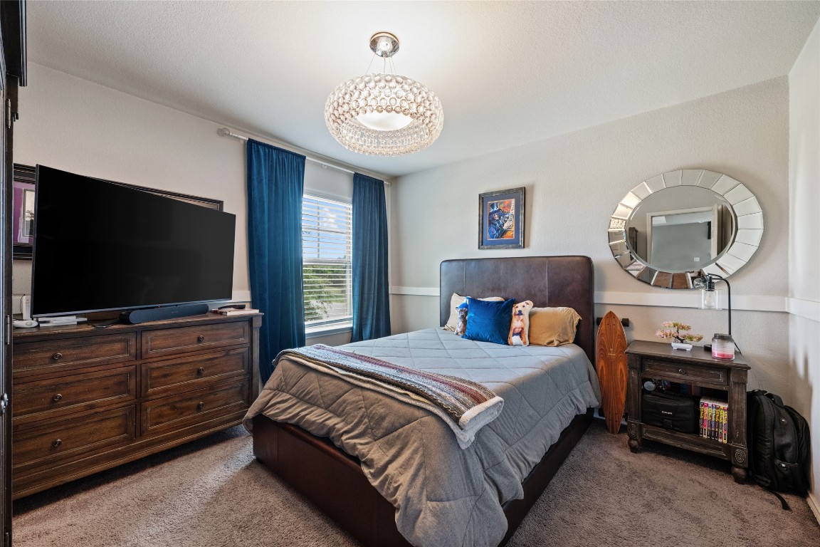 808 Bonnet Boulevard Georgetown, TX 78628 - Photo 24 of 40 a bedroom with a bed and a flat screen tv