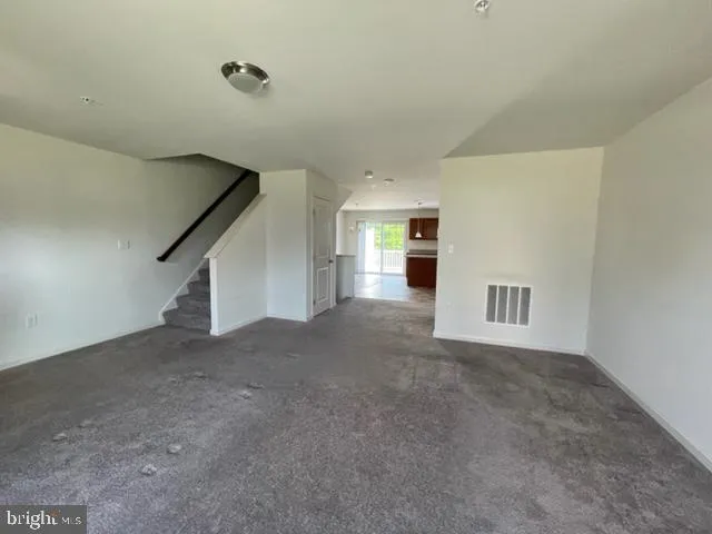 a view of a big room with closet and windows