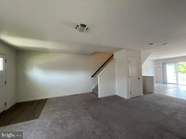 a view of a livingroom with an empty space and a window