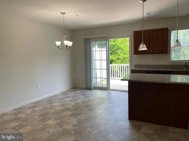 a view of a livingroom with wooden floor and window