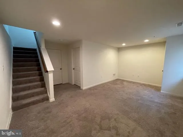 a view of an empty room with stairs