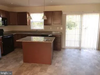 a kitchen with a stove a sink and a microwave