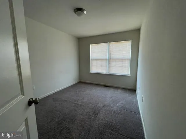 an empty room with a empty space and a window