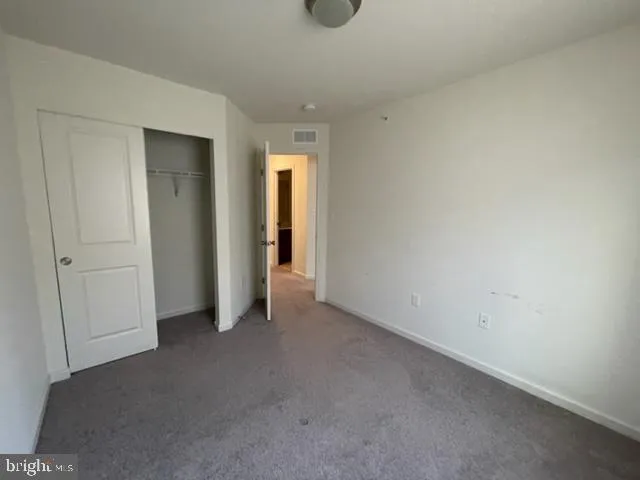 a view of an empty room and closet area