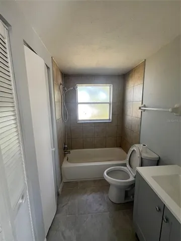 a bathroom with a sink a toilet and bathtub
