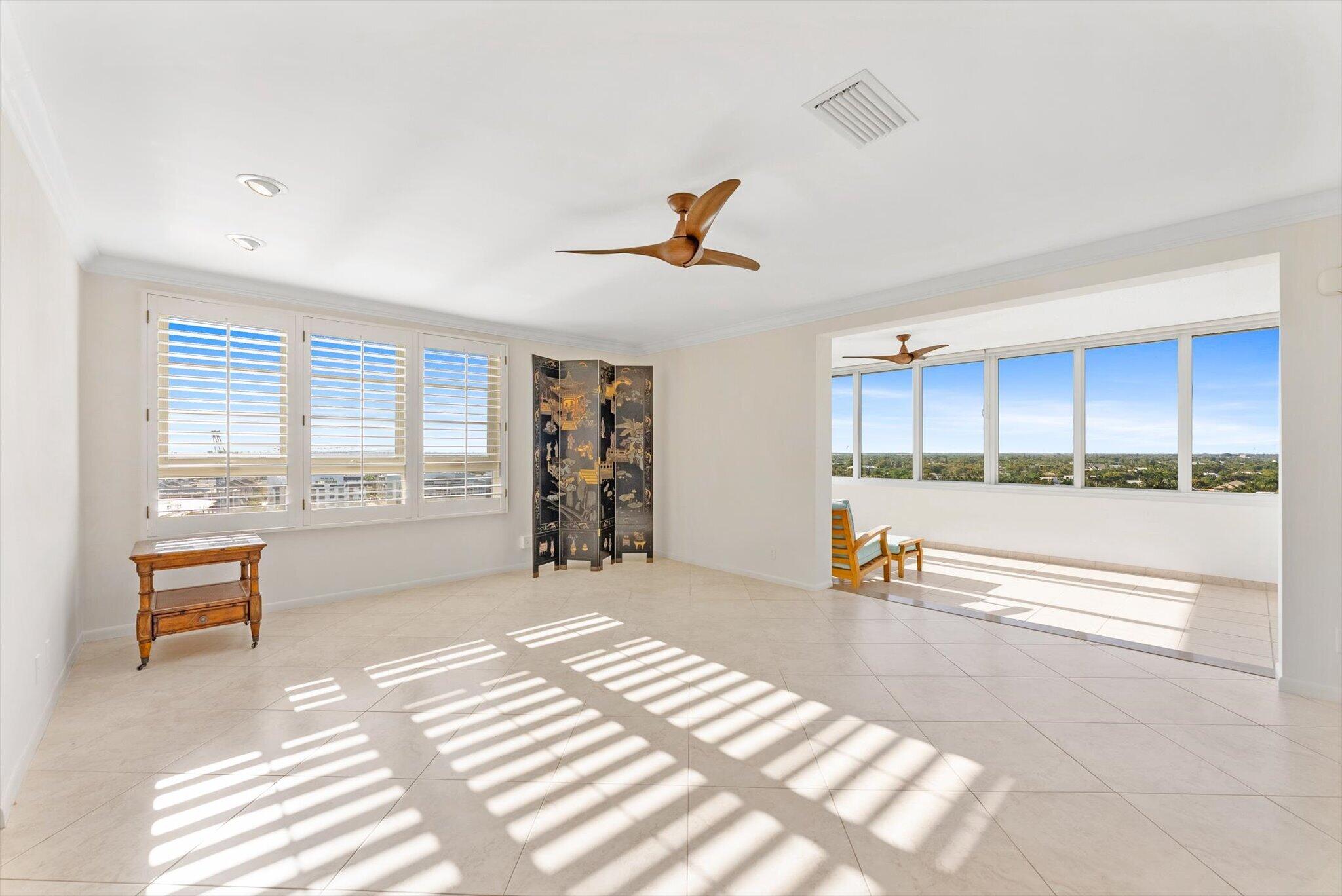 50 E Road, Unit 12A Delray Beach, FL 33483 - Photo 9 of 47 a living room with furniture and a large window