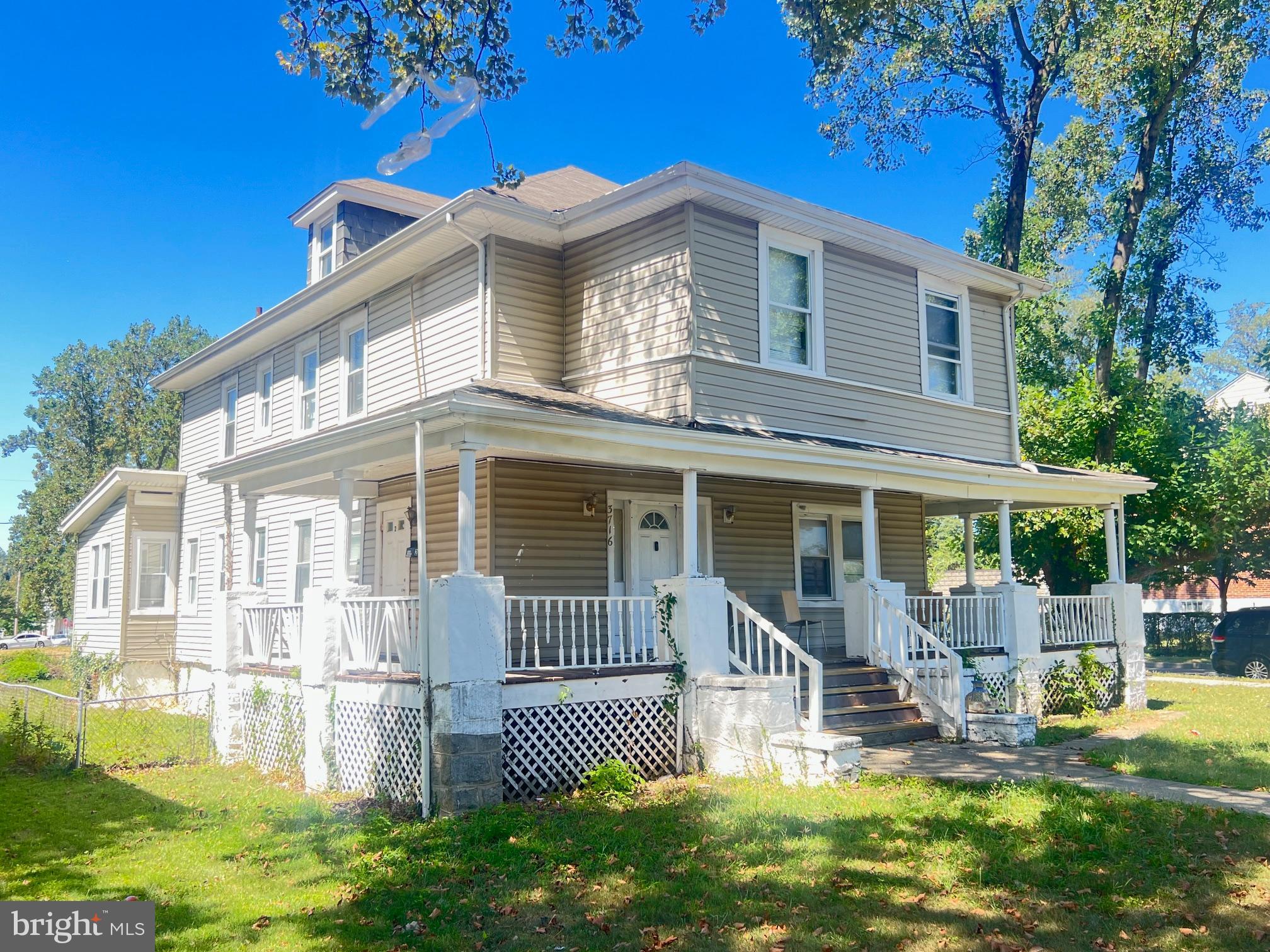 3716 Mohawk Avenue Baltimore, MD 21207 - Photo 4 of 4 a front view of a house with a yard table and chairs