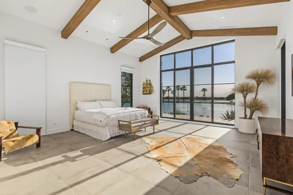 a bedroom with a bed and a large window