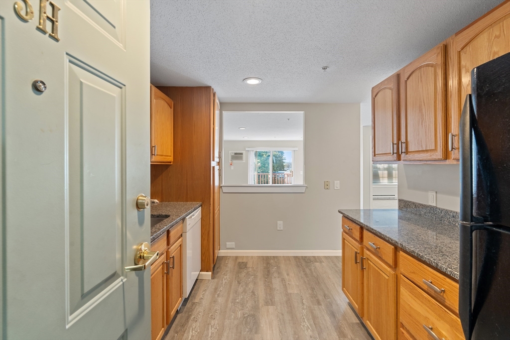 2 Ocean Avenue, Unit 3H Gloucester, MA 01930 - Photo 11 of 28 a view of a kitchen cabinets and wooden floor