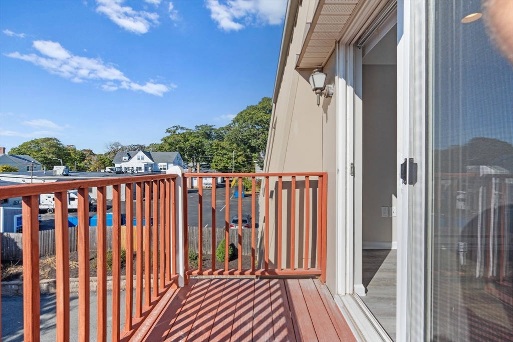 2 Ocean Avenue, Unit 3H Gloucester, MA 01930 - Photo 24 of 28 a view of a balcony with wooden floor and fence