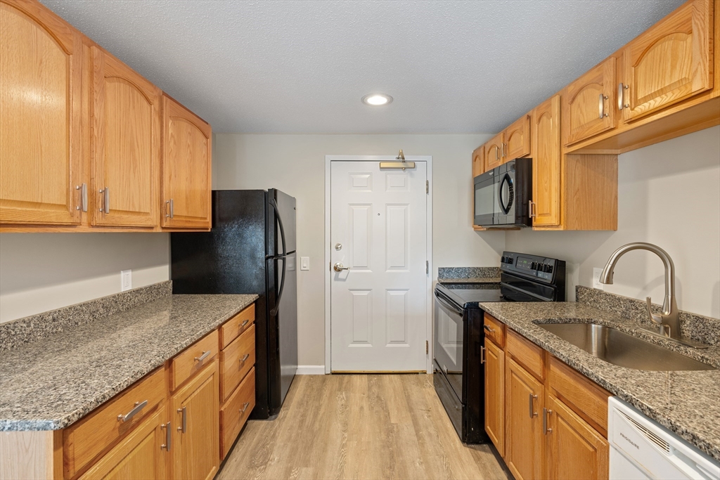 2 Ocean Avenue, Unit 3H Gloucester, MA 01930 - Photo 8 of 28 a kitchen with stainless steel appliances granite countertop a sink stove and refrigerator