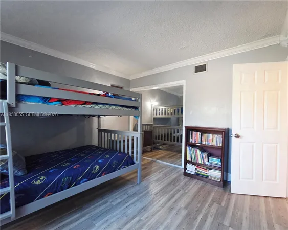 a bedroom with furniture and a book shelf