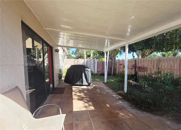 a view of a porch with furniture and garden
