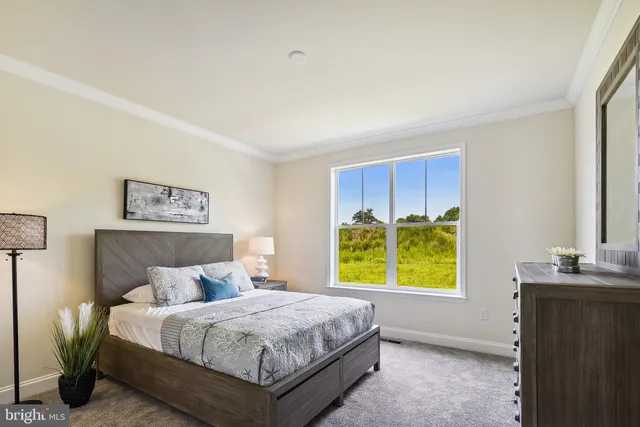 a bedroom with a bed and painting on the wall