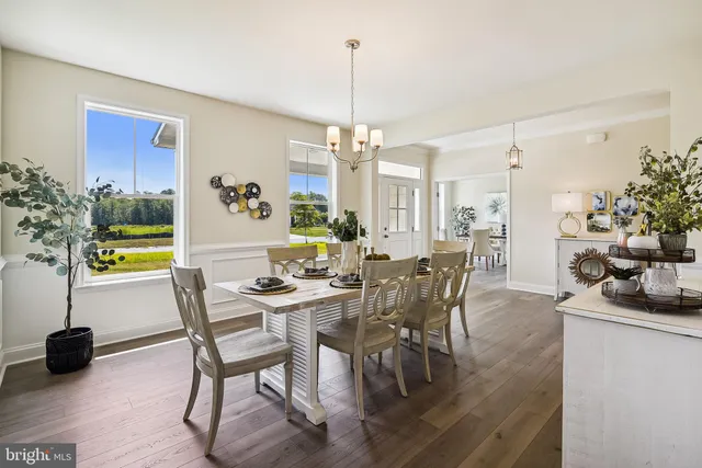 a view of a dining room with furniture and chandelier