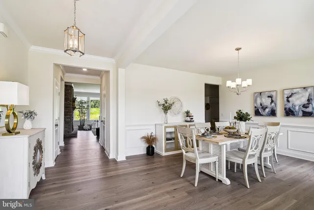 a view of a dining room with furniture wooden floor and a chandelier