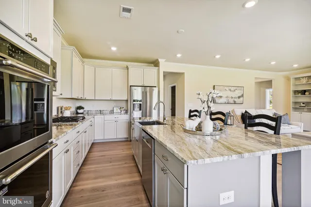 a kitchen with sink a counter top space a stove and cabinets