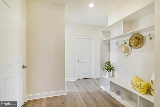 a view of walk in closet with window and wooden floor